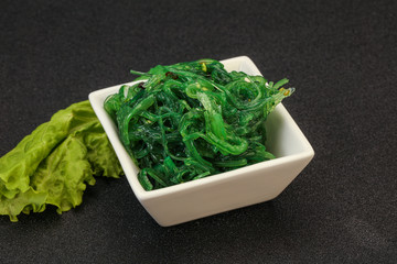 Green Chuka Seaweed Salad Isolated on White Background Top View. Wakame Sea Kelp Salat