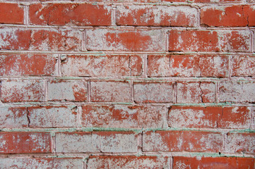 Texture of an old brick wall. Grunge red stone wall background. Old masonry, shabby facade. Vintage red brick wall.
