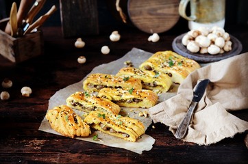 Homemade yeast pie with mushrooms on a dark wooden background, rustic style
