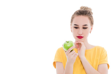 Emotional portrait of a girls who eat an apple on an isolated white background. The concept of a healthy diet, healthy lifestyle and vegetarianism