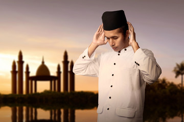Asian Muslim man in praying position (salat)