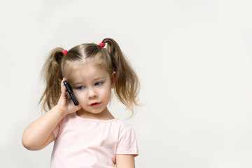 little girl speaks by cell phone