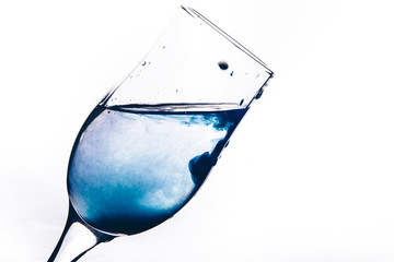 a stream of water pours into the glass. water splashes