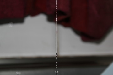 Close-up Of Dripping Water Against Wall