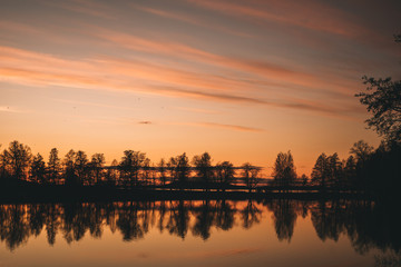 Orange sunset and reflect in the lake. 