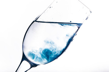 a stream of water pours into the glass. water splashes