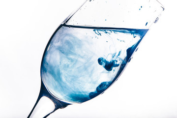 a stream of water pours into the glass. water splashes