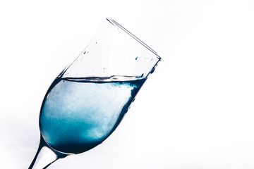 a stream of water pours into the glass. water splashes