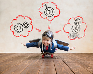 Portrait of young businessman with toy paper wings