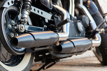 Low angle photograph of a dual exhaust motorcycle