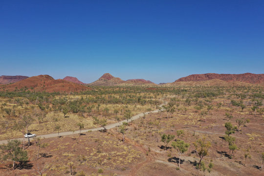 Drone Aerial View Of 4WD Vehicle Driving In Australia Outback