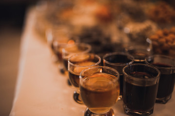 many glasses of wine. catering services in restaurant outdoor on wedding ceremony. Food and glass of champagne. restaurant