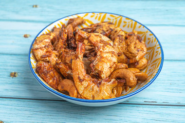 Thai food, Fried Crispy shrimp with herbs and spices on old ceramic dish with Blue Wooden Background , Flat Lay Out, Top View Angle