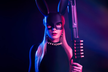 girl in a rabbit mask with a shotgun