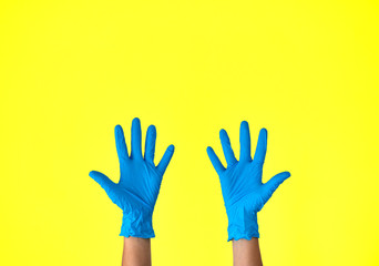 Human rising hands wearing blue disposable latex glove with open palms, rubber glove for professional medical safety and hygiene protection from Coronavirus disease COVID-19 and medical surgery