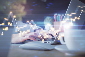 Double exposure of woman hands typing on computer and forex chart hologram drawing. Stock market invest concept.