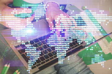 Double exposure of woman hands typing on computer and business theme hologram drawing. Success concept.