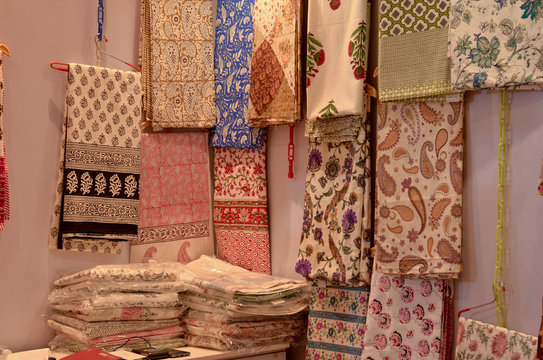 Fancy sarees / unstitched suits hanging and folded on display in a Swadeshi khadi handloom exhibition at Dilli Haat, New Delhi, India International Trade Fair (IITF)