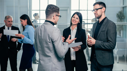 group of business people standing in the office lobby