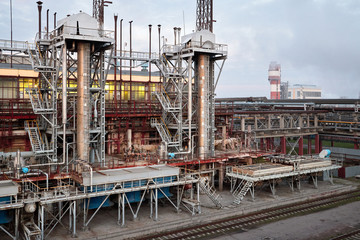 Fototapeta na wymiar At modern chemical plant. Air cooling system with electric motors and synthesis columns of chemical production