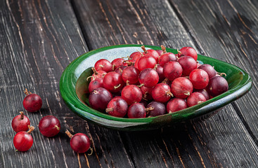 Red gooseberries on a dark table