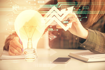 Multi exposure of woman on-line shopping holding a credit card and bulb drawing. Choice concept.