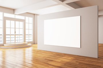 Gallery interior with big door to balcony and blank poster on wall.