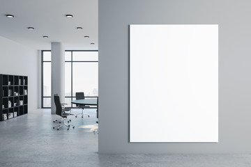 Clean meeting room with blank billboard on wall.