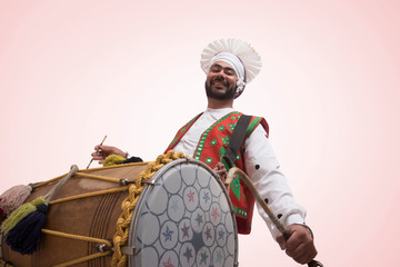 Sikh Man Playing On A Dhol
