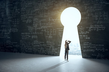 Businesswoman looking to keyhole with drawing mathematical formulas