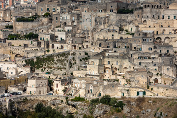 Fototapeta premium Panoramic view of Sassi di Matera a historic district in the city of Matera, well-known for their ancient cave dwellings from the Belvedere di Murgia Timone, Basilicata, Italy