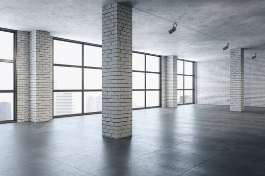 Modern gallery interior with brick columns and city view.