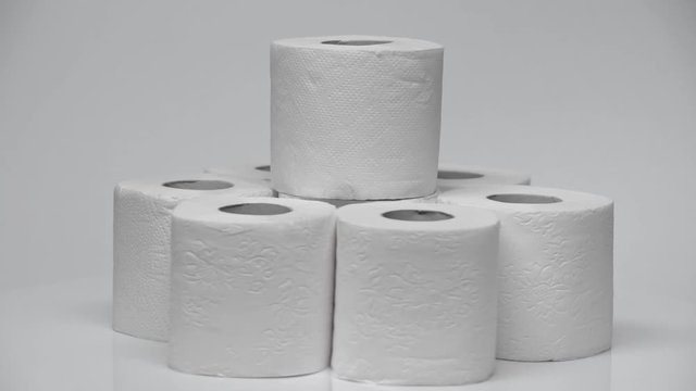 stacked and clean toilet paper rolling on white