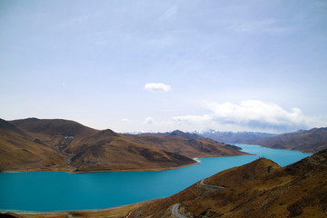 The brown peaks of YamdrokTso, the blue-green sacred lake, and Mani Dui and the dancing prayer flags.