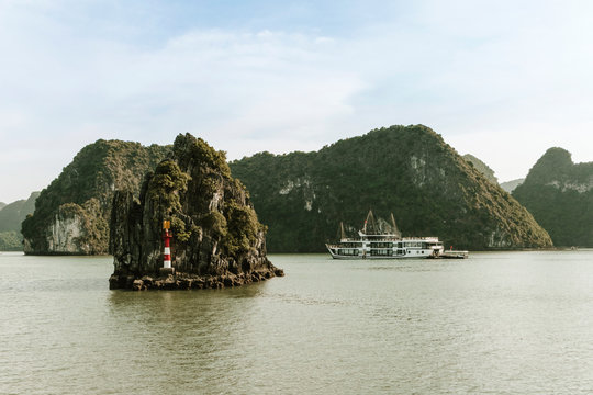 Tropical Lan Ha Bay landscape, Vietnam. Bay with karst islets and a cruise ship