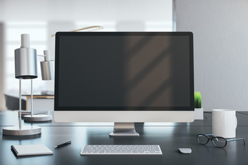Modern designer desktop with black computer screen
