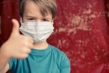 Portrait of Toddler kid wearing medical mask.A boy wearing mouth mask against pandemic. Concept of coronavirus quarantine or covid-19.Protection against virus and infection control concept.