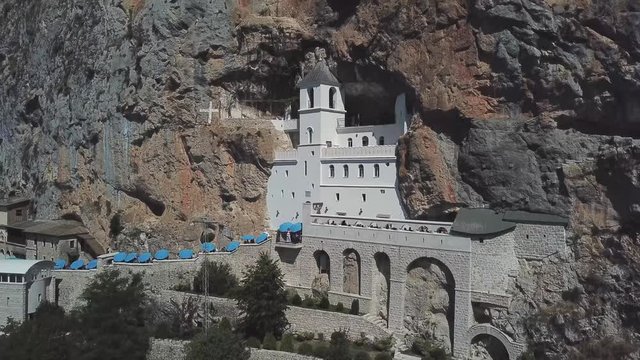 Aerial view of The Monastery of Ostrog, Serbian Orthodox Church situated against a vertical background, high up in the large rock of Ostro&scaron;ka Greda, Montenegro. Dedicated to Saint Basil of Ostrog 