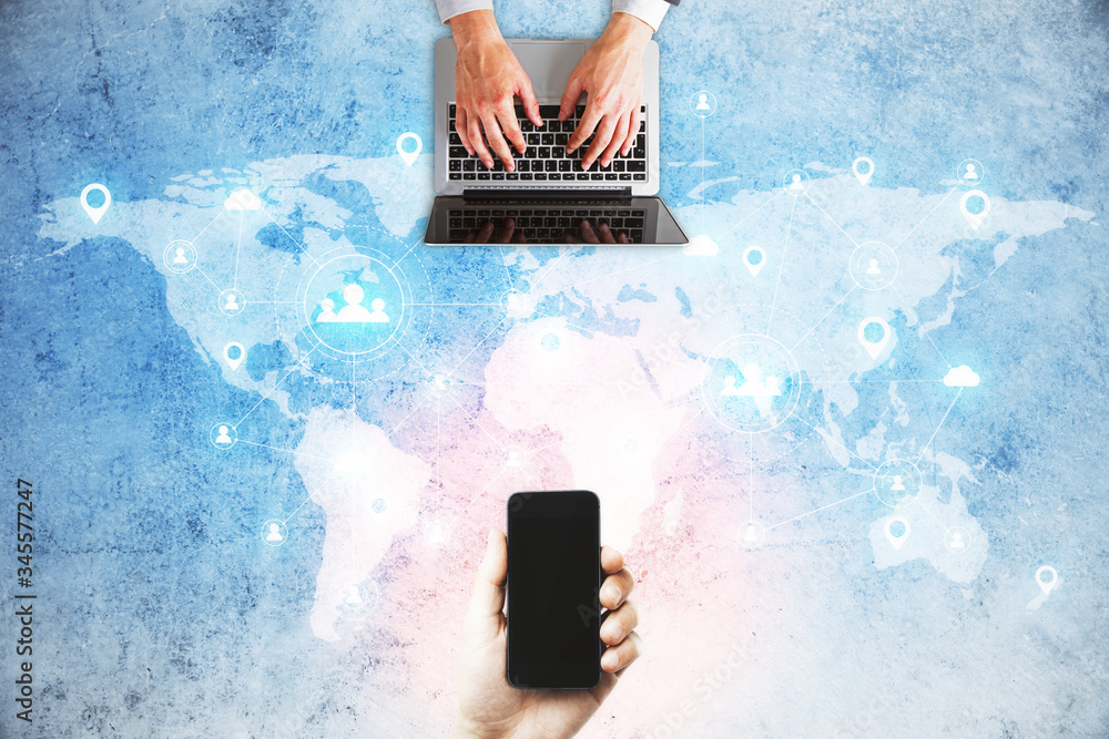 Poster hand typing on laptop and using smartphone and social media network
