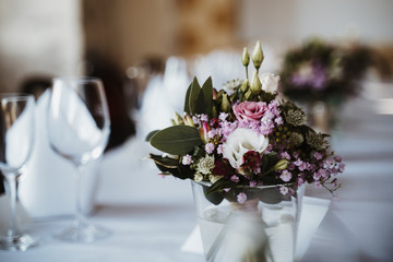photo of flowers on a table in a vase with plates