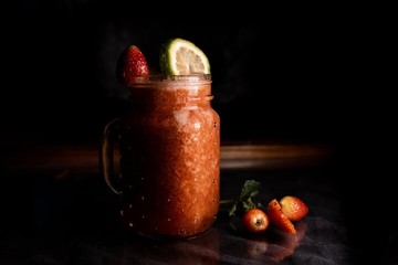Jar of Strawberry Juice in black background
