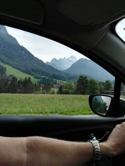 Shot out of driving car with mountains