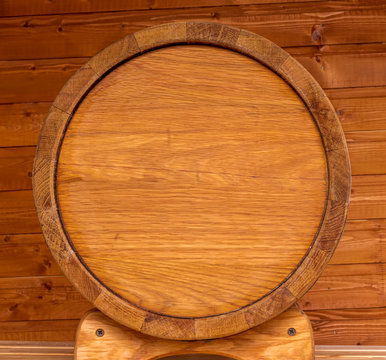 wooden oaken barrel on a ginger wood backgroung , beer kask with copyspace close up , vine vat of oak