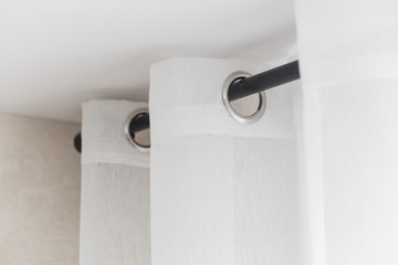 The white curtains with ring-top rail