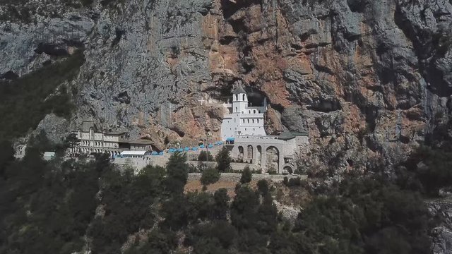 Aerial view of The Monastery of Ostrog, Serbian Orthodox Church situated against a vertical background, high up in the large rock of Ostro&scaron;ka Greda, Montenegro. Dedicated to Saint Basil of Ostrog 