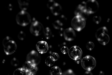 blurred transparent soap bubbles floating on the dark, bubbles abstract background, black background