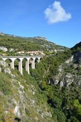 Road from Nice to Italy. View from the Moenne Kornice scenic road to the viaduct (stone Arch bridge) near the Eze village.