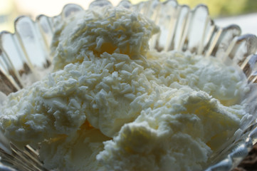 White ice cream with coconut in a glass plate