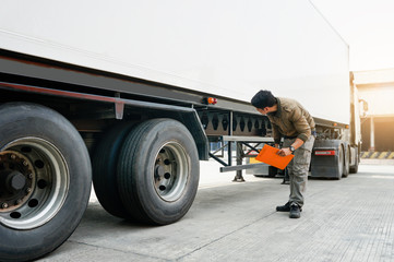 Asian truck driver holding clipboard inspecting around truck, vehicle maintenance safety checklist...