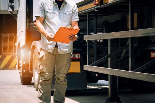 truck driver holding clipboard inspecting safety checklist semi truck, vehicle maintenance daily checklist, road freight industry logistics. - Powered by Adobe